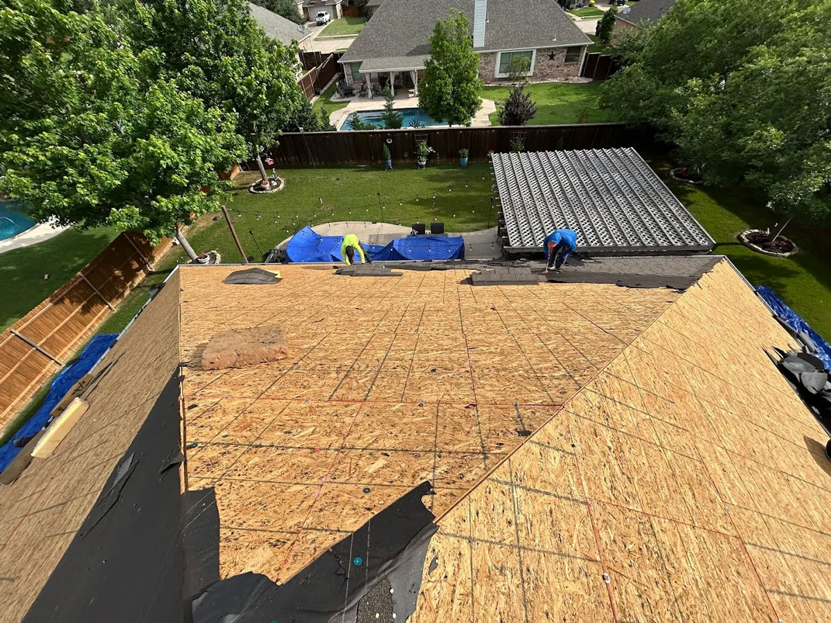 Roofing crew working in summer heat on a Wylie Texas residential roof