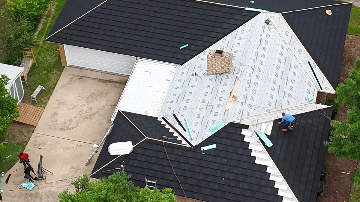 Professional roof inspector examining shingles on a Weatherford Texas home