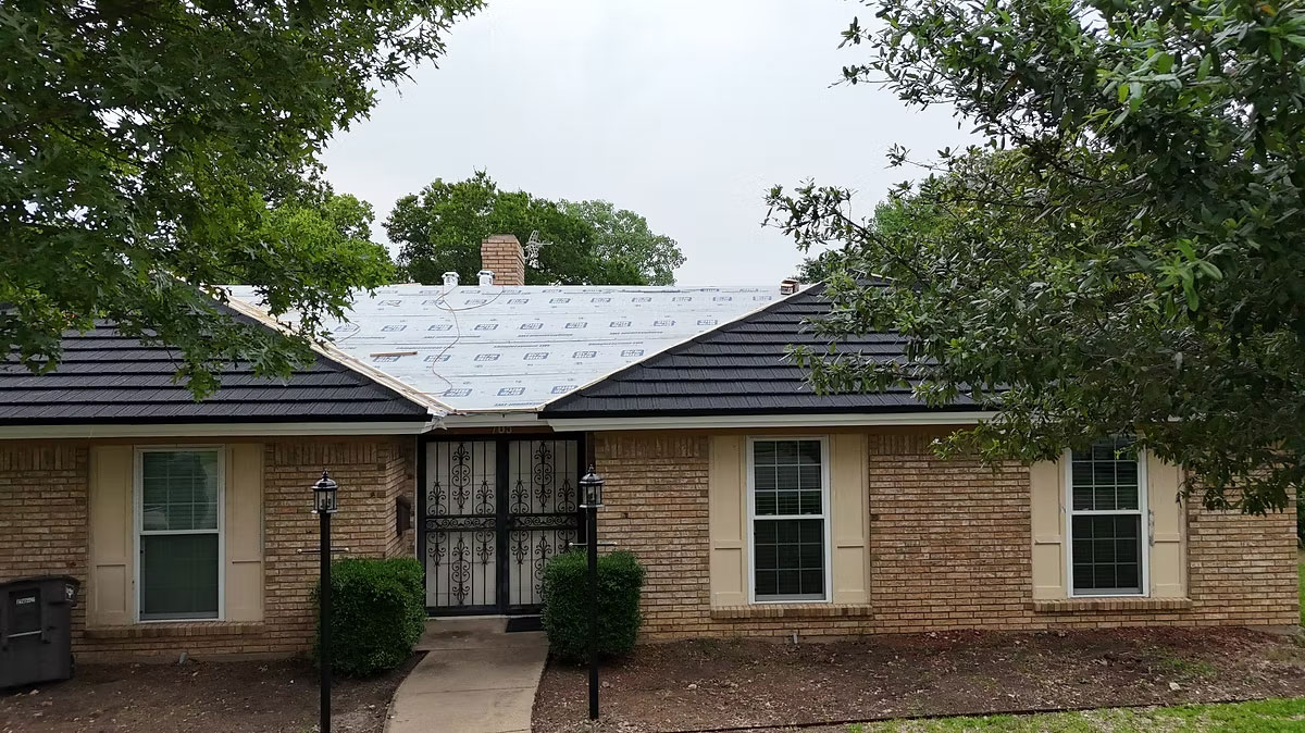 Aging roof with curling shingles on a Dallas Texas home
